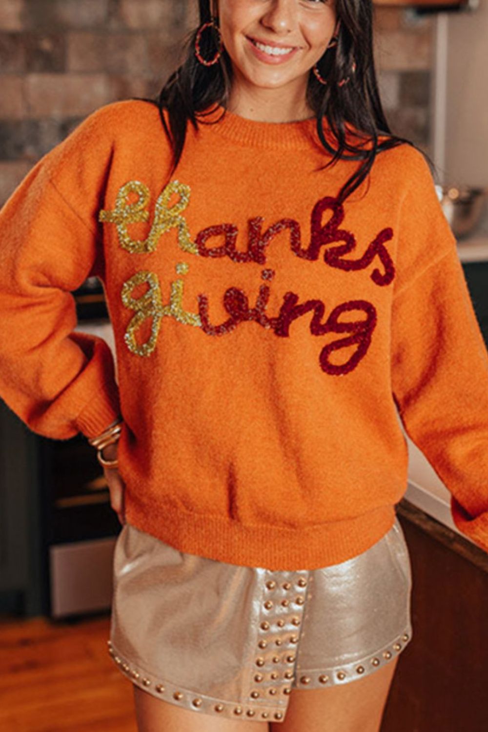 Orange sweater with sequin "thanks giving" script, crew neck, long sleeves.