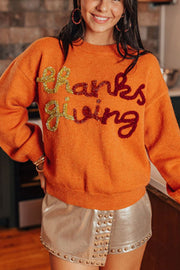 Orange sweater with sequin "thanks giving" script, crew neck, long sleeves.