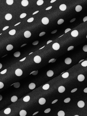 Black and white polka dot fabric detail of a ruffled crop top and skirt set.