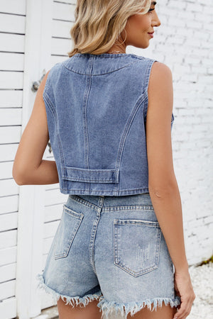 Medium wash denim cropped vest with button details and a raw hem.