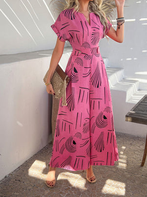Hot Pink geometric print wide-leg jumpsuit with V-neck and short sleeves.