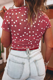 Sheer deep red t-shirt with white hearts, short sleeves, and a fitted cut.