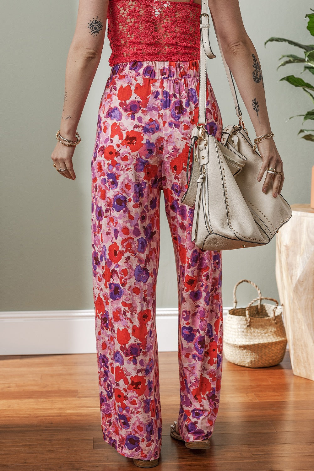 Painterly floral palazzo trousers in strawberry pink with a wide leg and elastic waist.