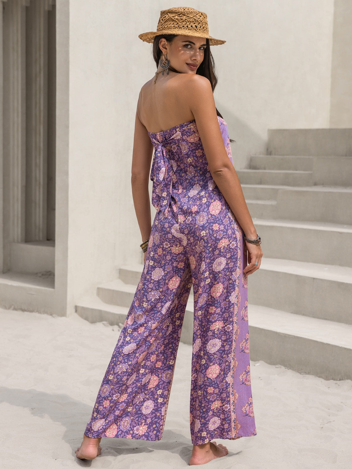 Lilac floral bandeau jumpsuit with wide legs and a tie back detail.