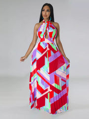 Halter neck maxi dress with geometric print and pleats in red, blue, green, and purple.