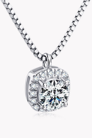 Silver halo diamond pendant necklace with a round-cut center stone and cubic zirconia accents.