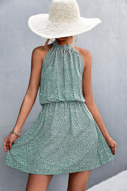 Yellow Green halter neck mini dress with a white floral print and elastic waist.