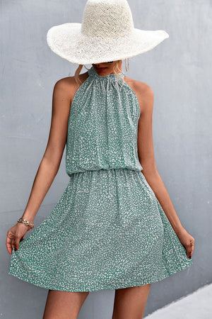 Yellow Green halter neck mini dress with a white floral print and elastic waist.