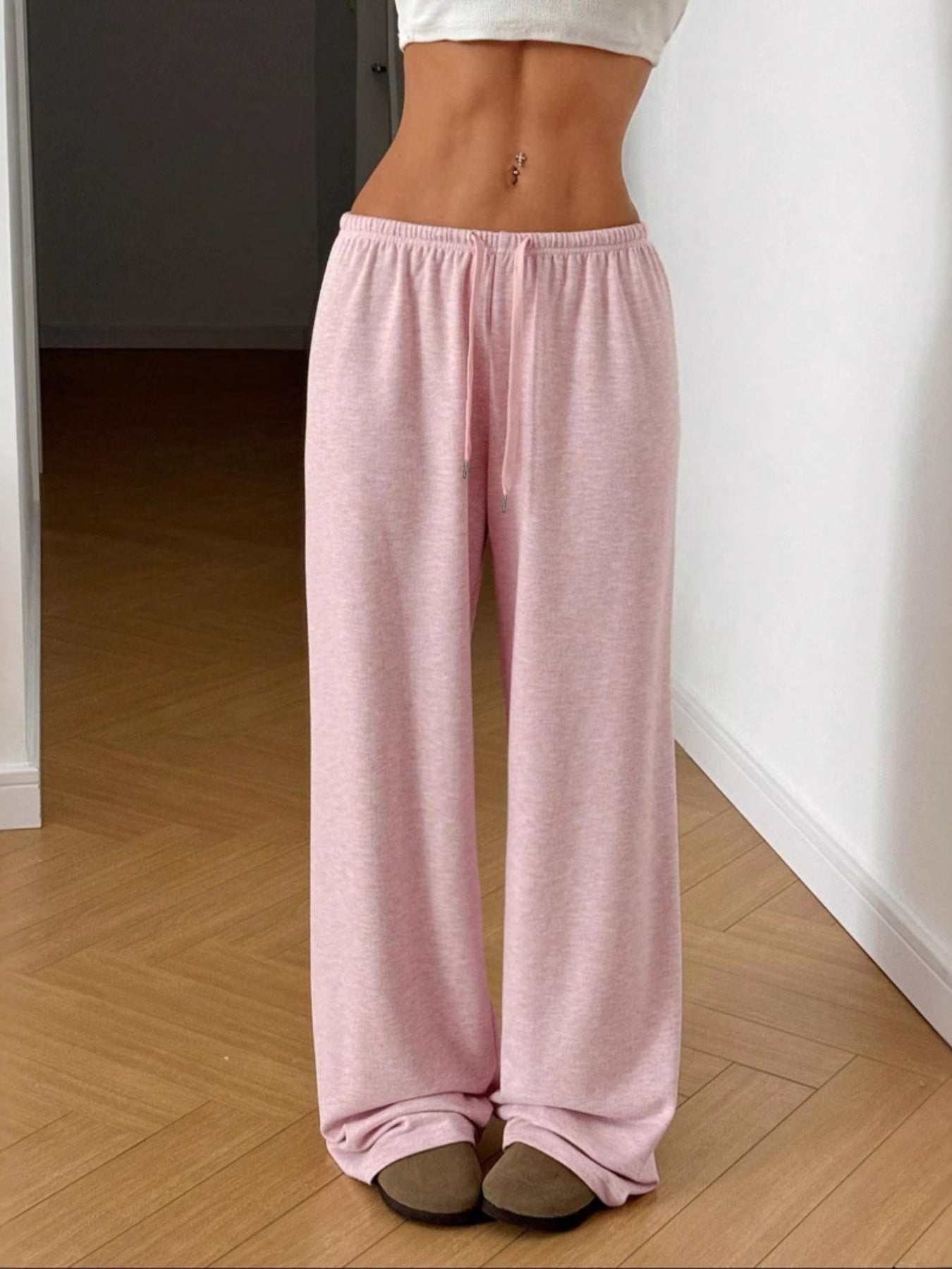 Blush pink casual wide-leg drawstring maternity pants with a relaxed fit.