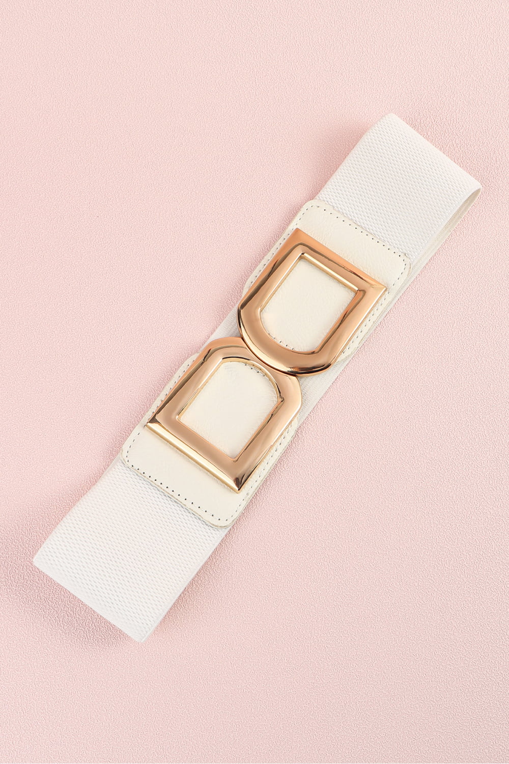 White elastic belt with double gold D-ring buckles and faux leather accents.