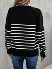 Black and white striped knit sweater with scalloped trim neckline and ribbed cuffs.