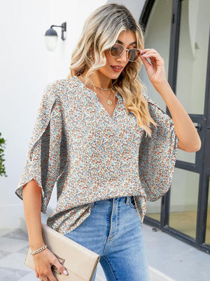 Floral print blouse with flutter sleeves and V-neck, made of polyester.