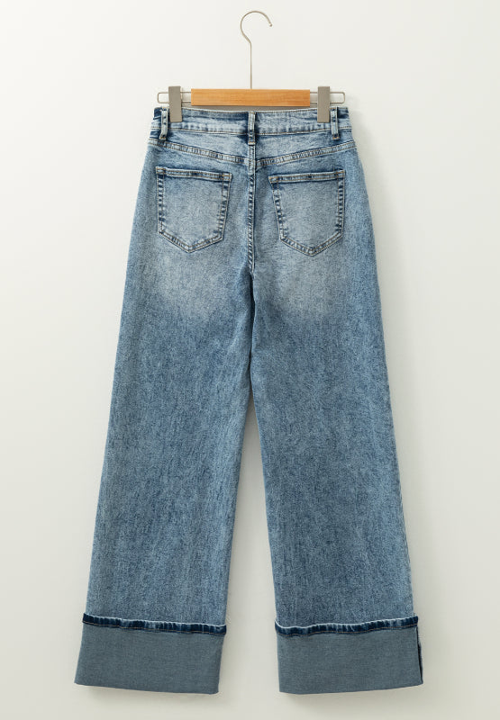 Medium washed denim jeans with cuffed hems and a wide leg.