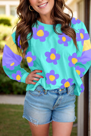 Daisy print crewneck top in pastel blue with colorblock sleeves and a casual fit.