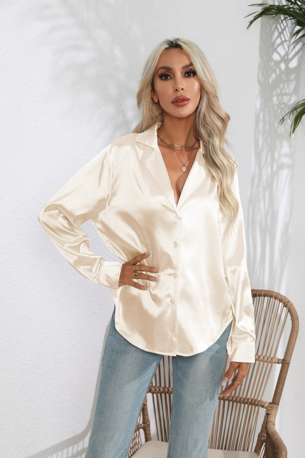 Glossy satin button-down blouse in cream with a relaxed fit and collared neckline.