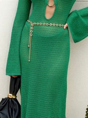 Green knit maxi dress with keyhole neckline and bell sleeves, cinched with a chain belt.