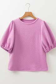 Textured quilted puff sleeve blouse in pink purple with crew neck and elastic cuffs.