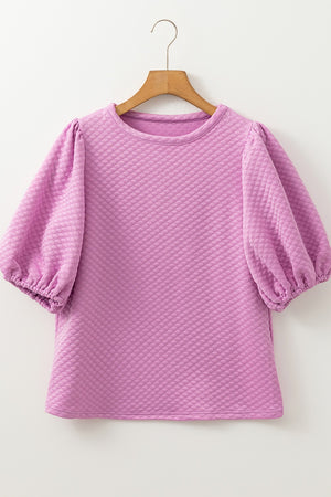 Textured quilted puff sleeve blouse in pink purple with crew neck and elastic cuffs.