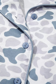 Camouflage print button-down pajama top with blue piping and buttons.