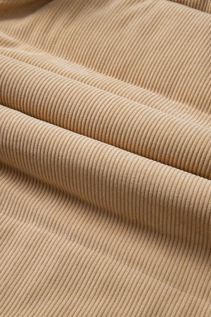Tan corduroy padded vest fabric detail with soft texture and vertical wales.