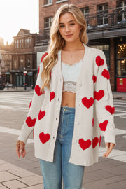 Beige knit cardigan with red heart appliqués, button front, long sleeves