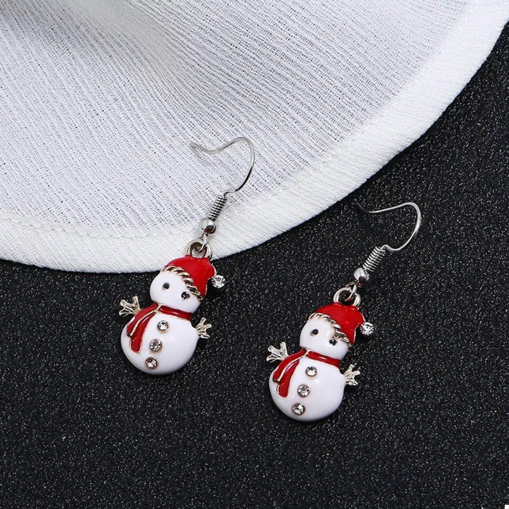 Festive snowman charm drop earrings with red hats and scarves, featuring crystal accents.