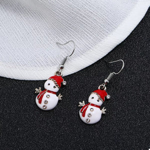 Festive snowman charm drop earrings with red hats and scarves, featuring crystal accents.