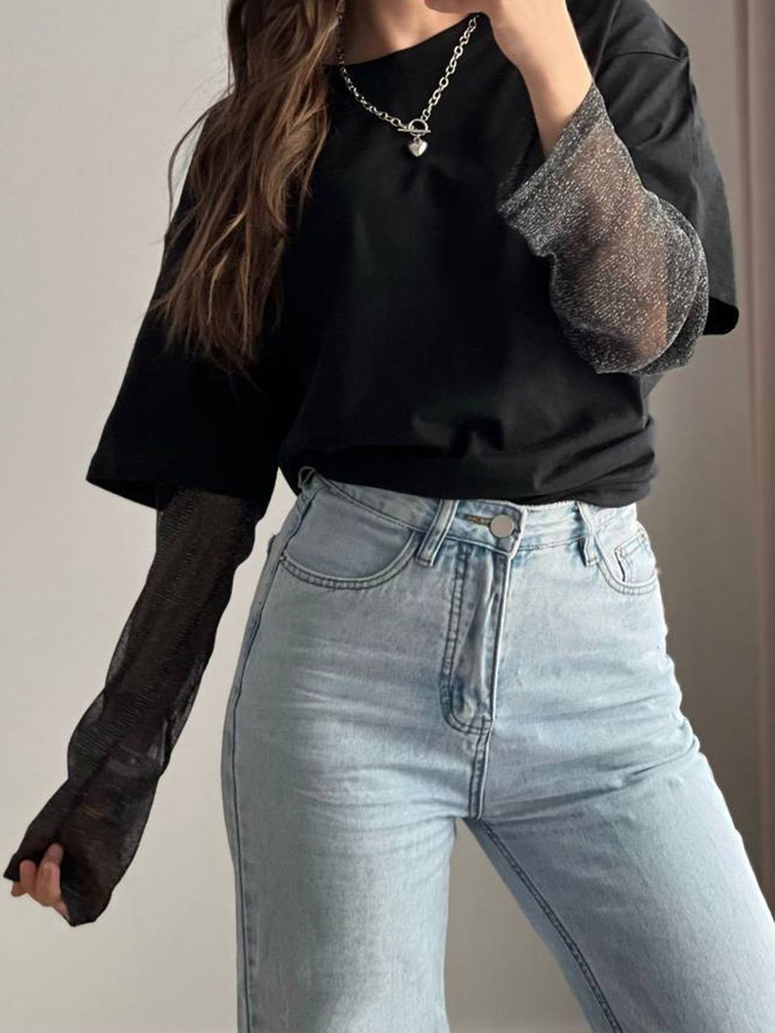 Black oversized tee with sheer sparkly sleeves and crew neck.