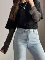 Black oversized tee with sheer sparkly sleeves and crew neck.