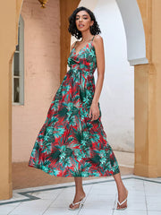 Chic floral midi dress with spaghetti straps in red and green tropical print.