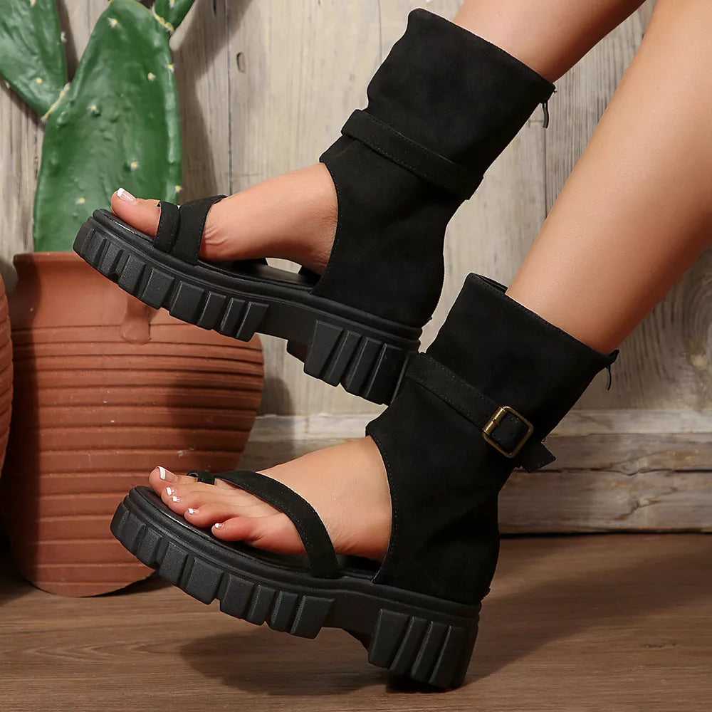 Black ankle bootie platform sandals with adjustable strap and chunky sole.