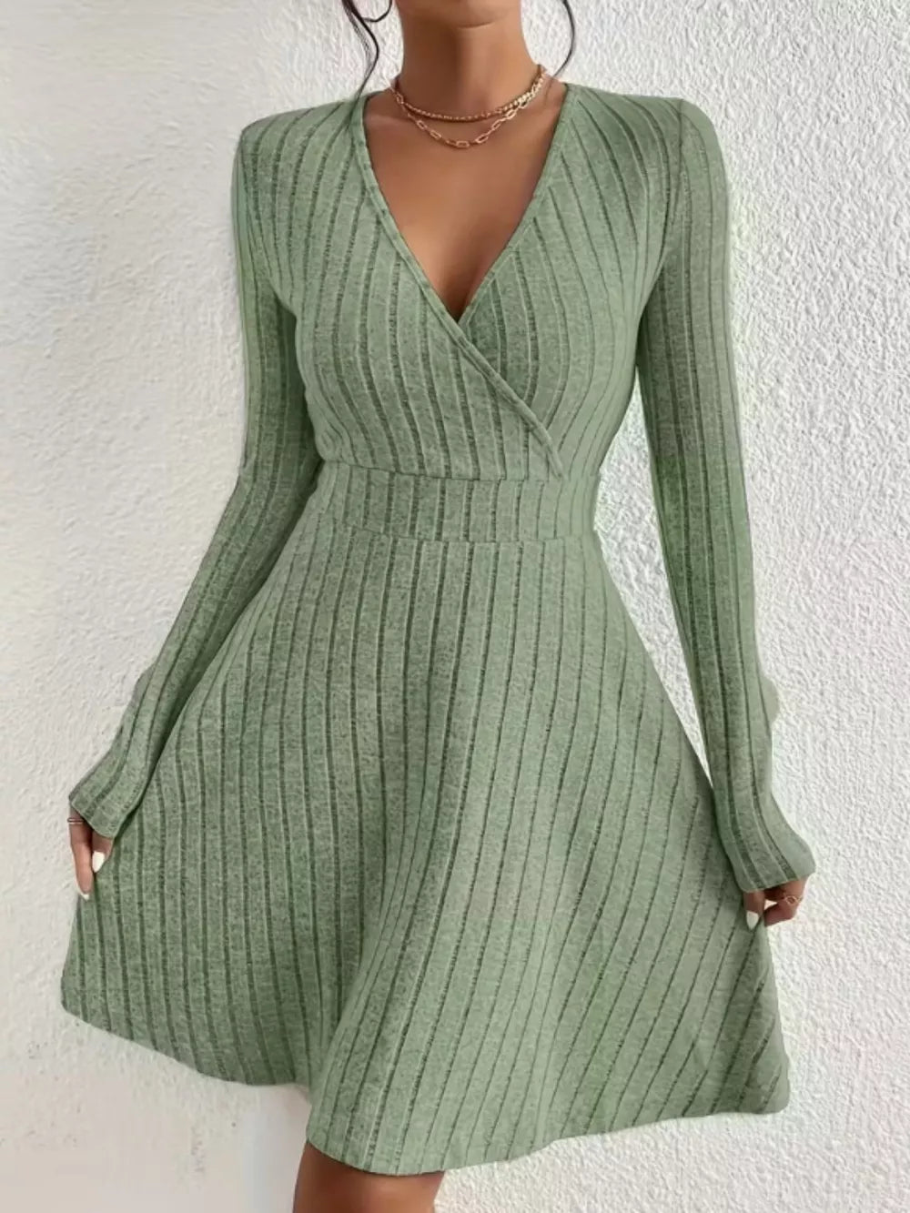 Sage green ribbed wrap mini dress with long sleeves and V-neck.