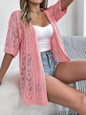 Pink open-knit pointelle cardigan with short sleeves and cable knit trim.
