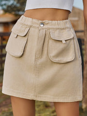 Khaki denim mini skirt with elastic waist and button detail.