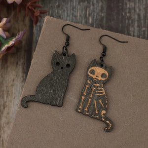 Black laser-cut cat earrings, one with a skeleton design, made of alloy.