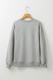 Gray crewneck sweatshirt with ribbed cuffs and hem, casual style.