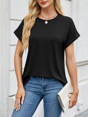 Black crew neck t-shirt with cuffed sleeves, styled with jeans and a clutch.