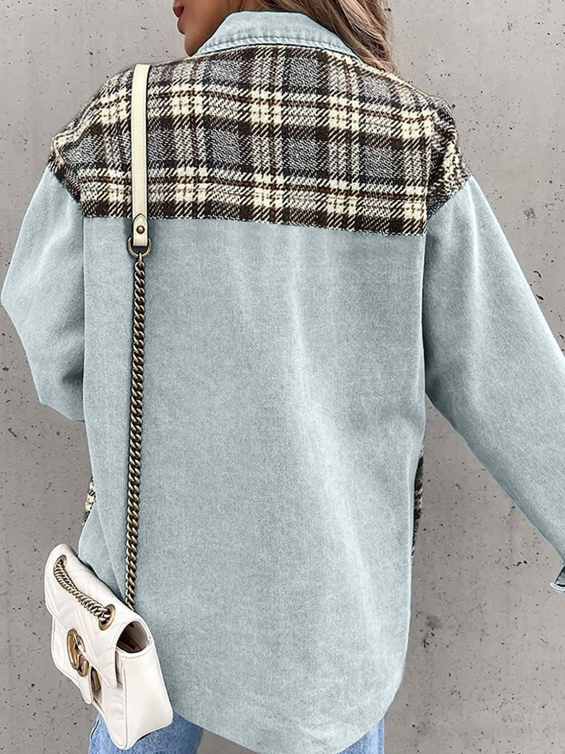 Light blue denim jacket with plaid paneling on shoulders and back, long sleeves.