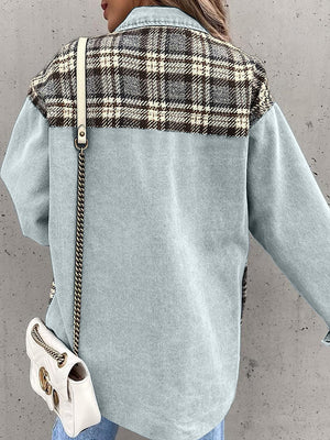 Light blue denim jacket with plaid paneling on shoulders and back, long sleeves.