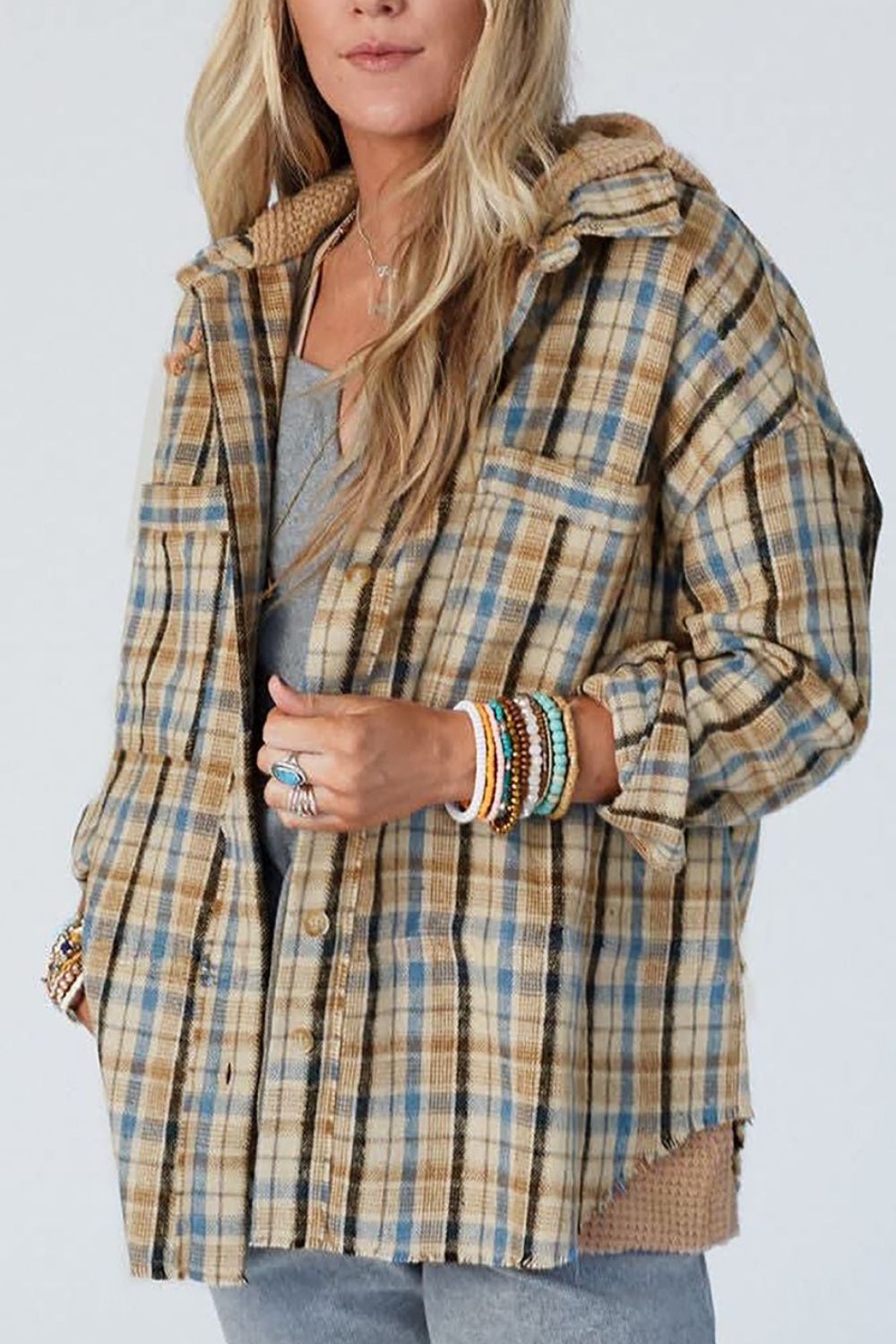 Textured plaid hooded overshirt with raw hem and cozy knit details.