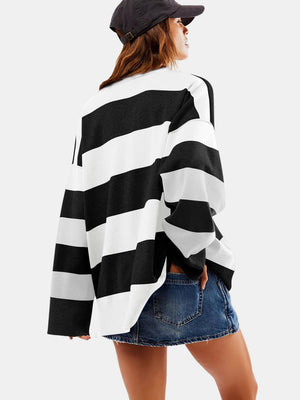 Oversized black and white striped knit pullover with a zip-up neckline.