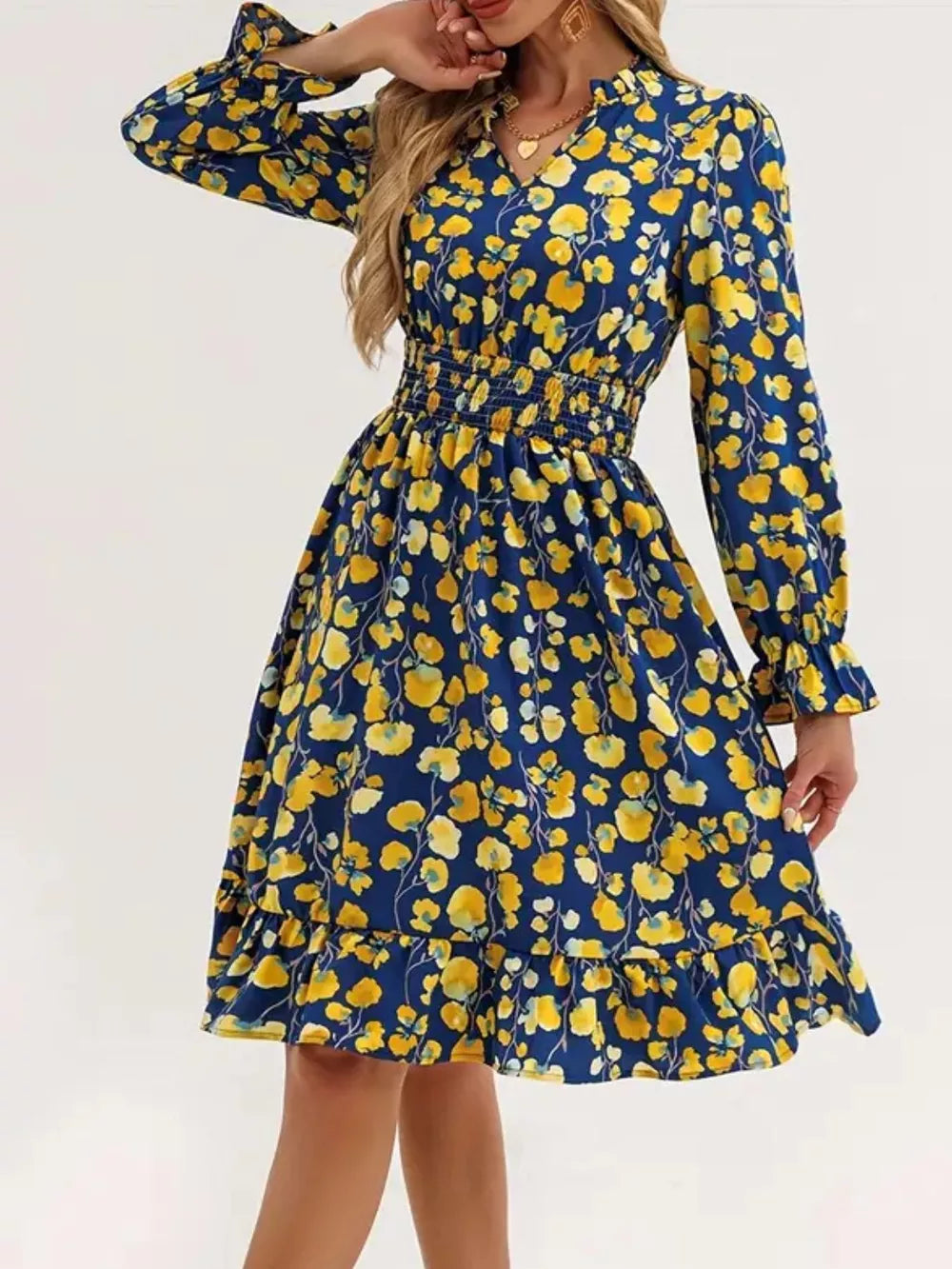 Blue floral smocked dress with ruffled cuffs and hem