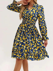 Blue floral smocked dress with ruffled cuffs and hem