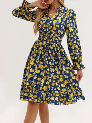 Blue floral smocked dress with ruffled cuffs and hem