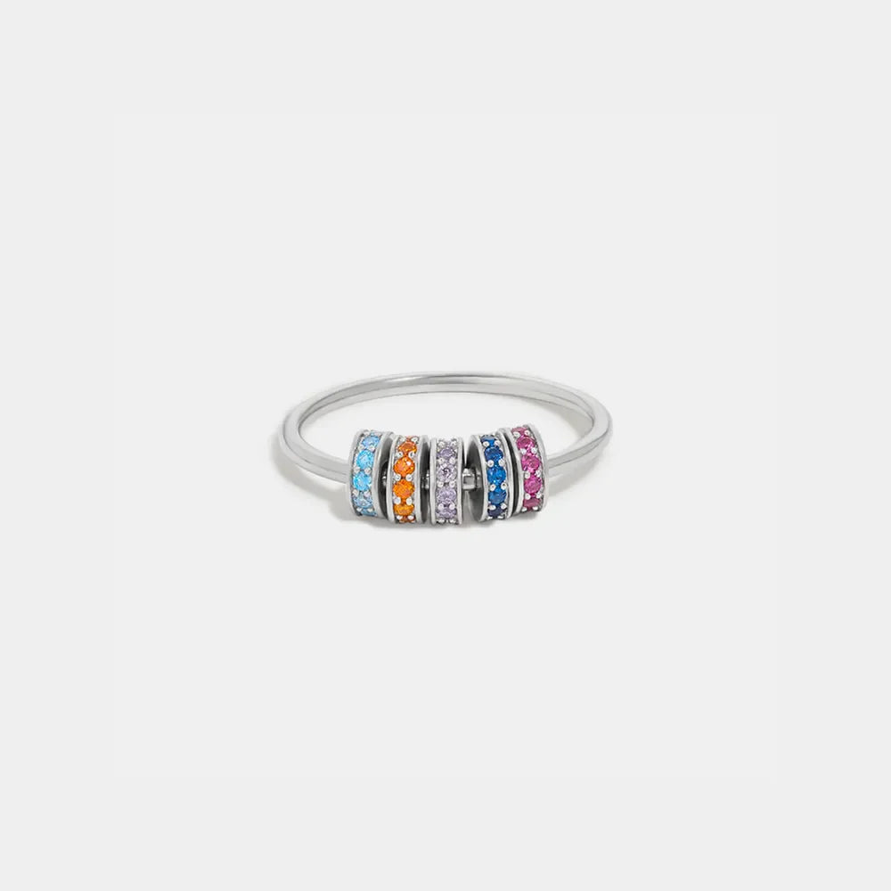 Sterling silver ring with five colorful pavé charm beads in blue, orange, purple, dark blue, and pink.