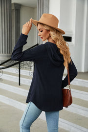 Navy textured henley hooded tunic with long sleeves and a curved hem.