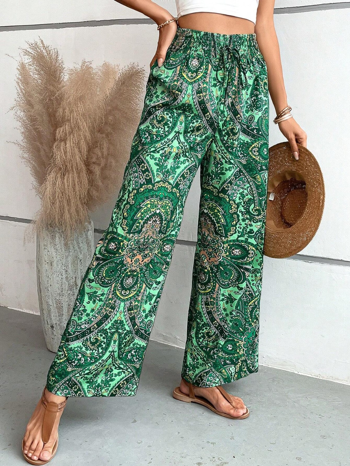 Paisley palazzo trousers in Dark Green with drawstring waist and wide legs.