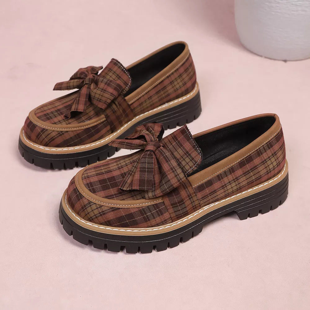 Plaid chunky loafers in tan with bow accent and lug sole.
