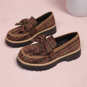 Plaid chunky loafers in tan with bow accent and lug sole.