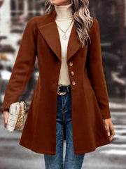 Brown wool blend coat with button closure and flared hem, styled with jeans.
